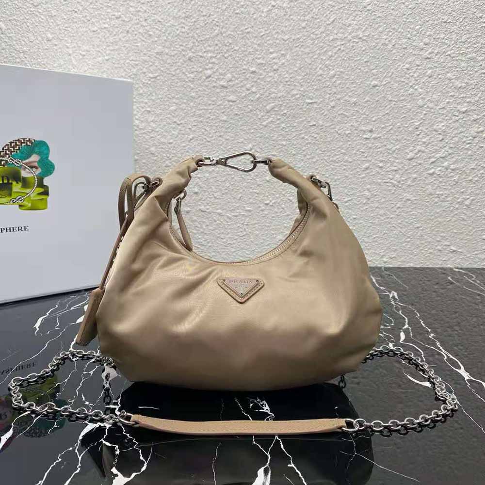 Close-up of silver hardware and Prada triangle logo on the Prada Women Re-Edition 2006 Nylon Bag-Sandy