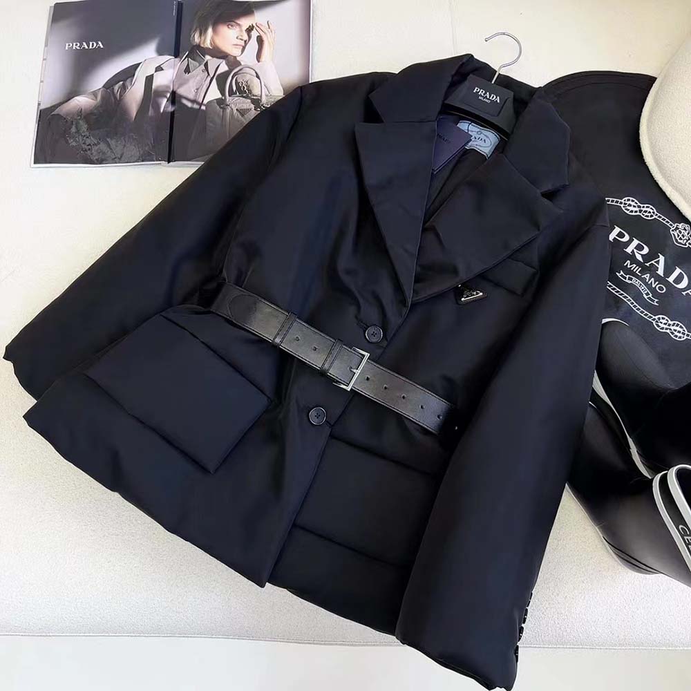 Close-up of textured gabardine and metal Prada logo detail on jacket