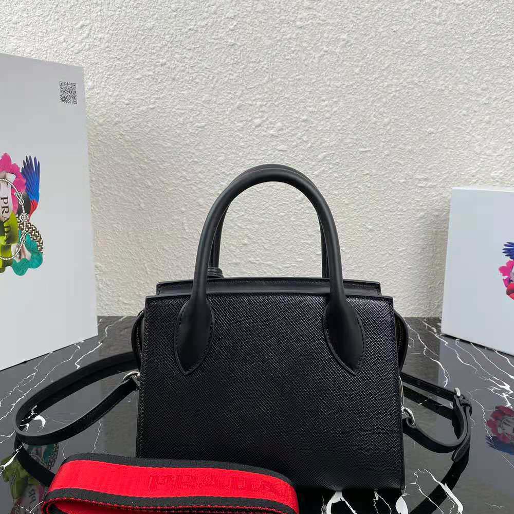Side angle showing adjustable strap on Prada Women Monochrome Saffiano Leather Bag-Black