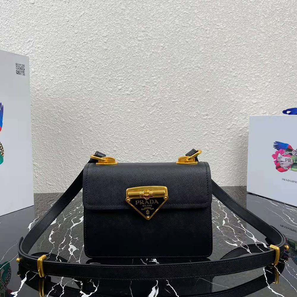 Close-up of green saffiano leather texture and gold Prada Symbole logo