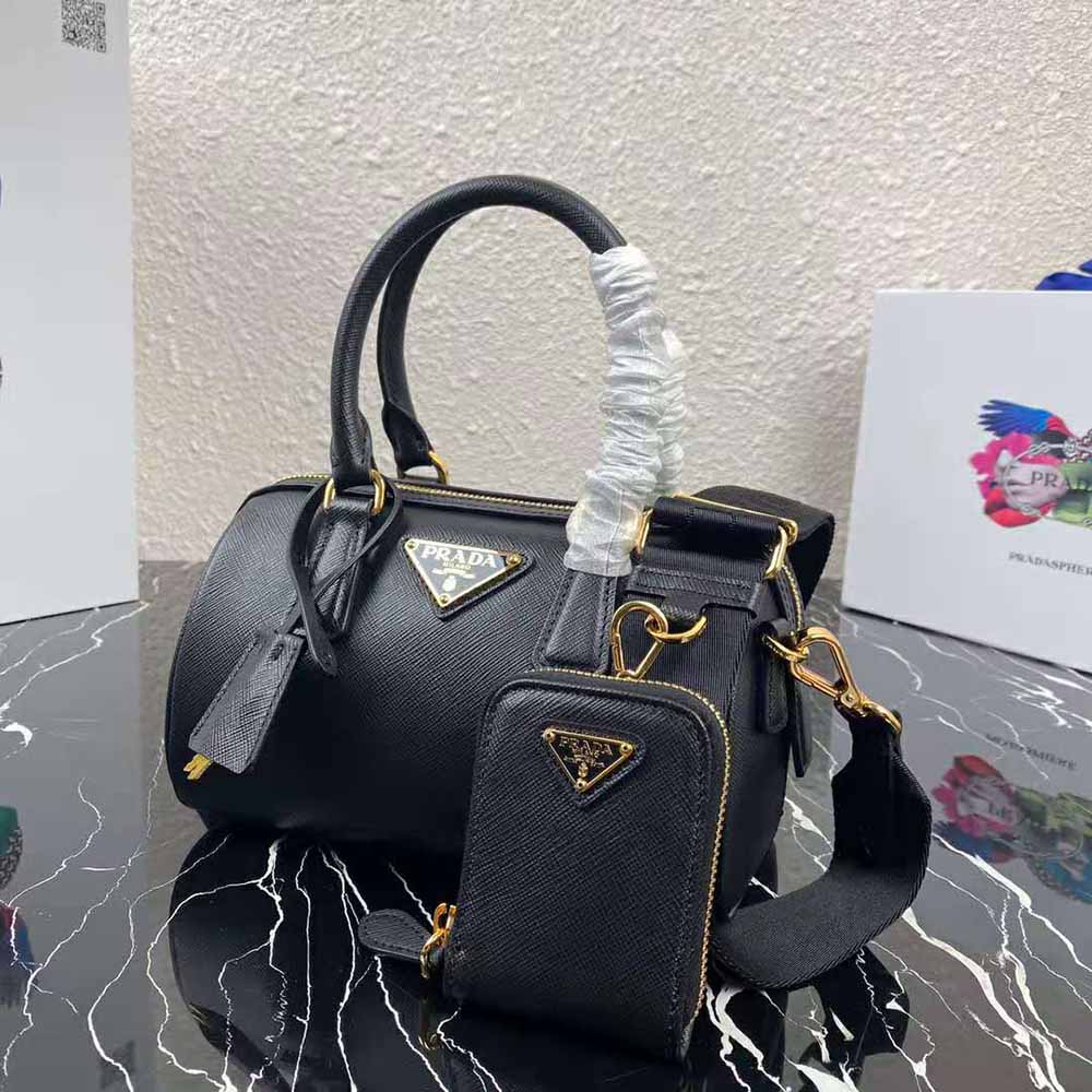 Side angle emphasizing structured silhouette of Prada Women Saffiano Leather Top-handle Bag-Black