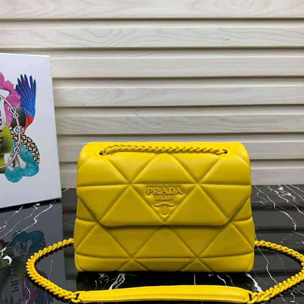 Close-up of yellow nappa leather and Prada logo hardware on the bag