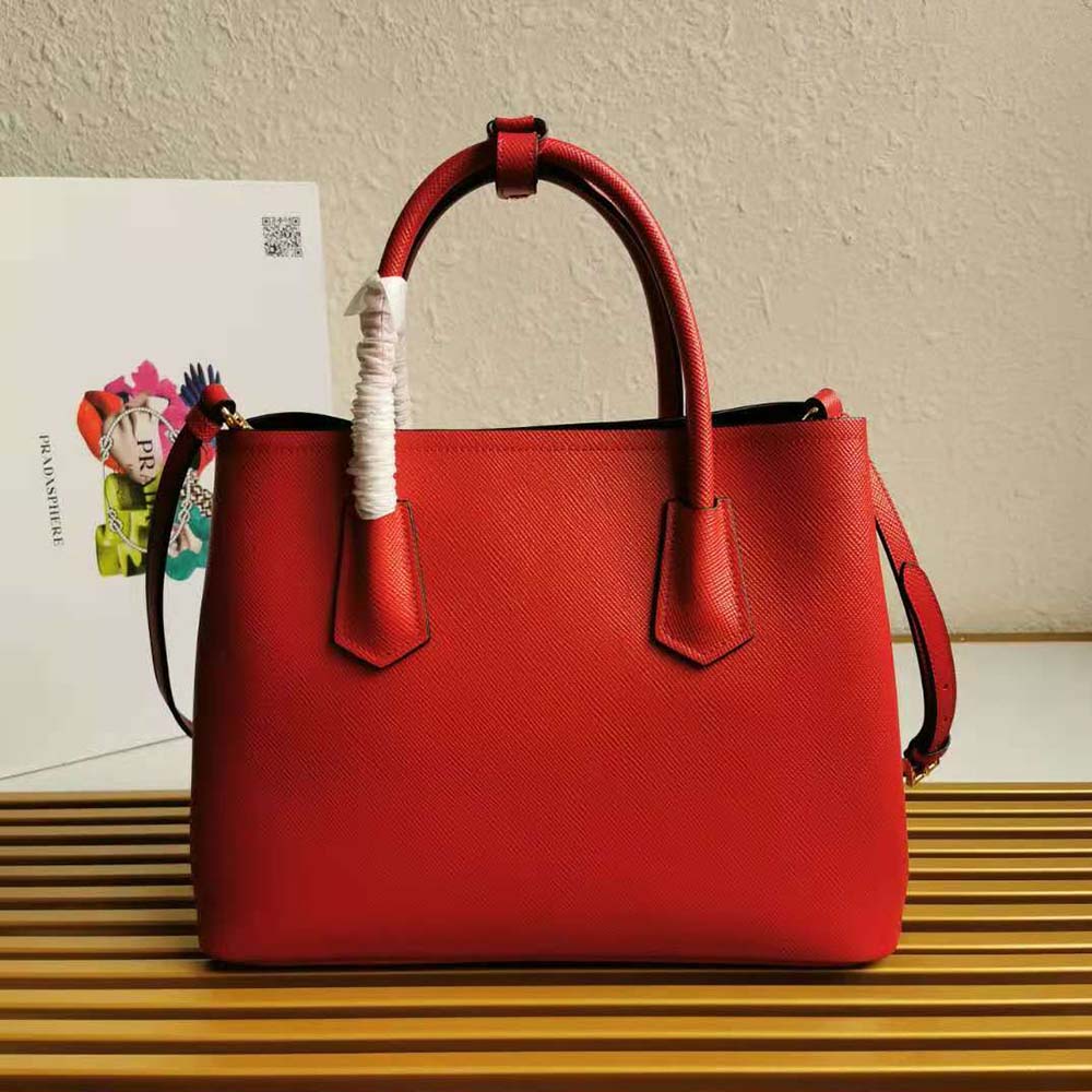 Side angle showing structured silhouette of Prada Women Small Saffiano Leather Double Prada Bag-Red