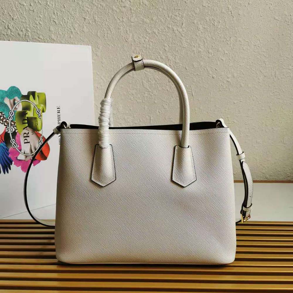 Side angle showing slim double-compartment design of Prada Women Small Saffiano Leather Double Prada Bag-White
