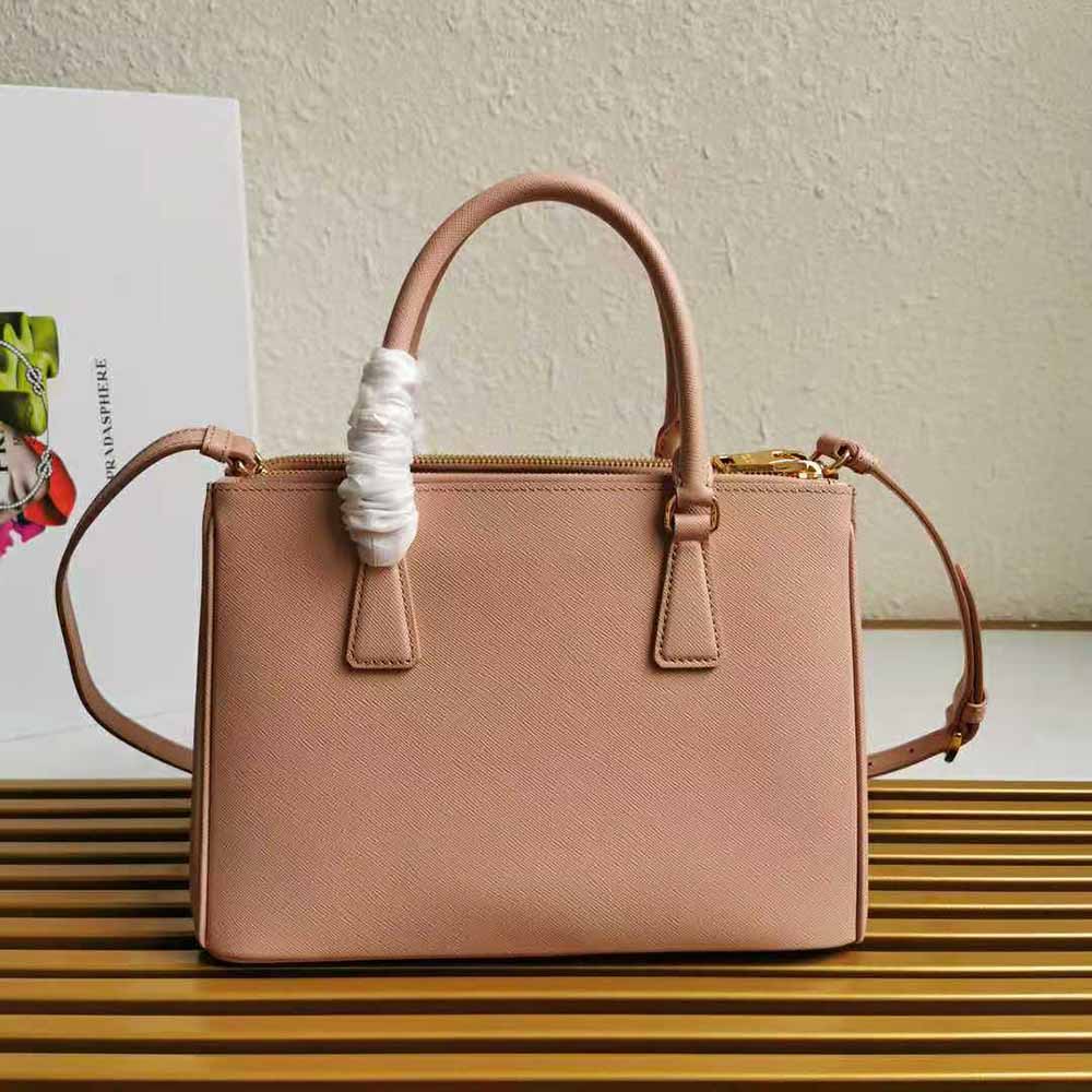 Side angle showing structured silhouette of Prada Women Small Saffiano Leather Prada Galleria Bag-Sandy