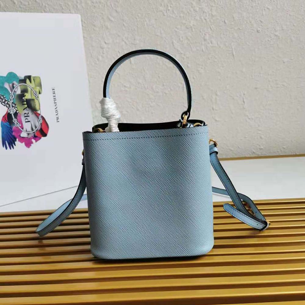 Side angle showing compact shape of Prada Women Small Saffiano Leather Prada Panier Bag-Blue
