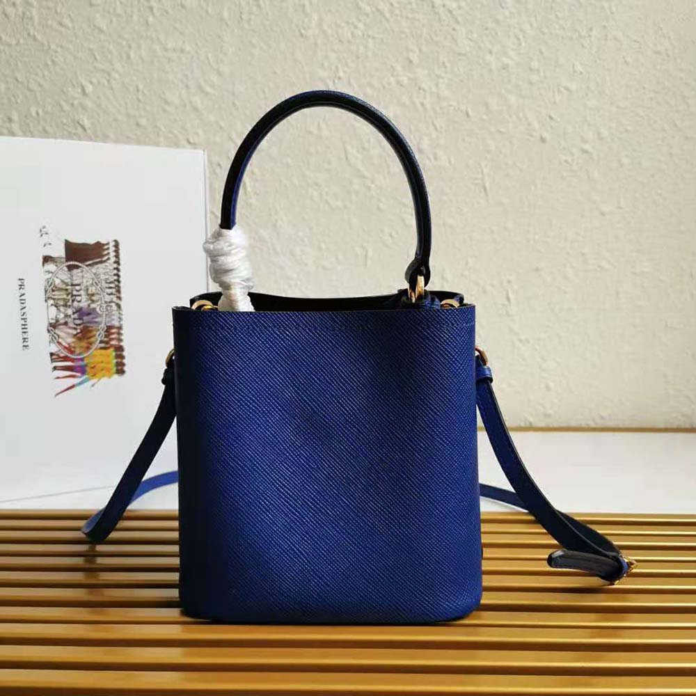 Side angle showing silver hardware and zip closure on Prada Panier