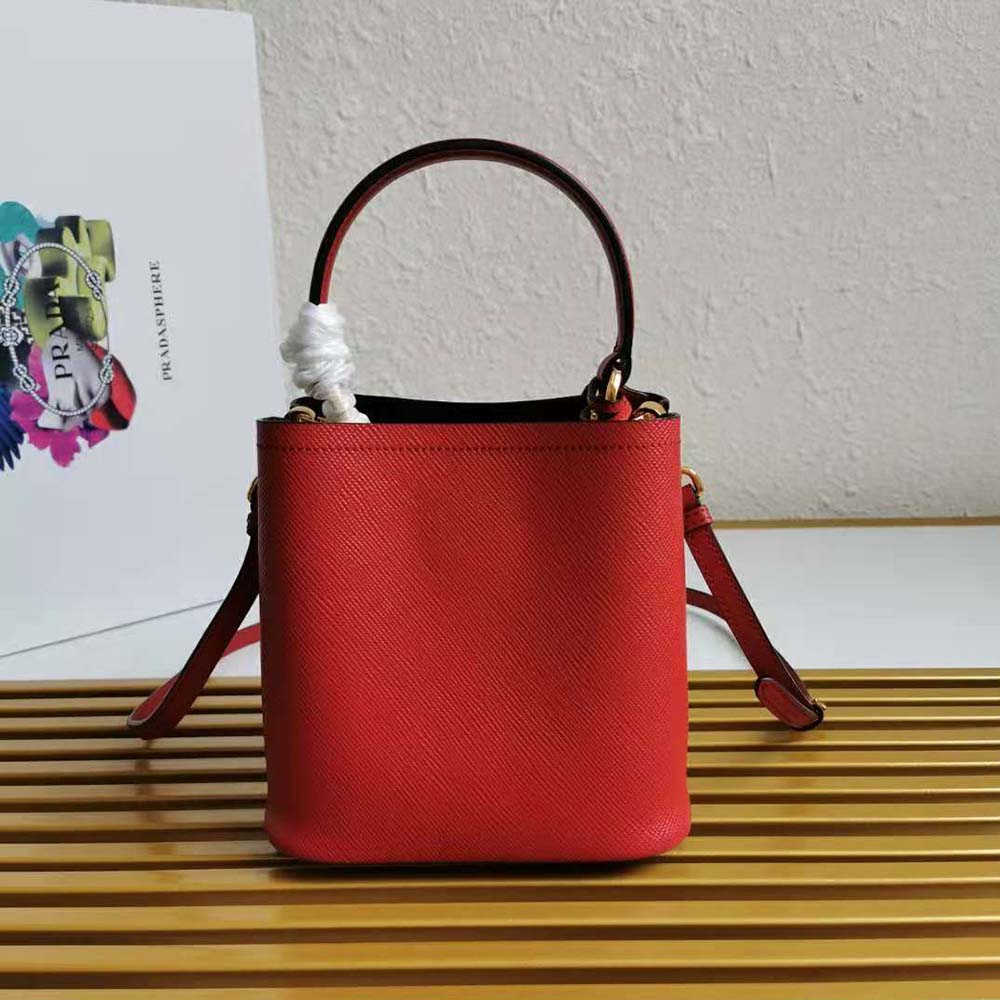 Side angle showing compact silhouette of Prada Women Small Saffiano Leather Prada Panier Bag-Red