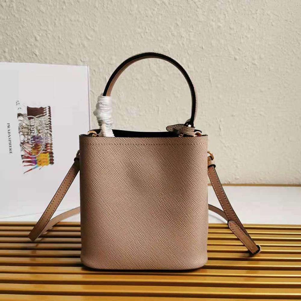 Side angle showing structured silhouette of Prada Women Small Saffiano Leather Prada Panier Bag-Sandy