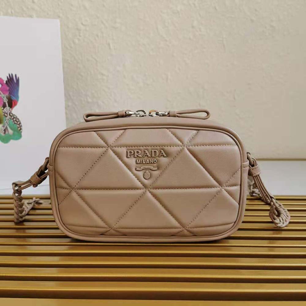Close-up detail of pink nappa leather and silver logo on Prada bag