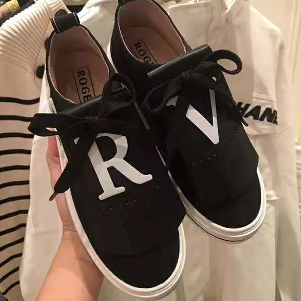 Close-up of silver buckle and patch detail on Roger Vivier Call Me Vivier Patch Sneakers