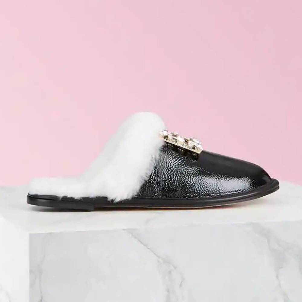 Side angle of Roger Vivier Women Hotel Vivier Broche Vivier Buckle Mules in black patent leather
