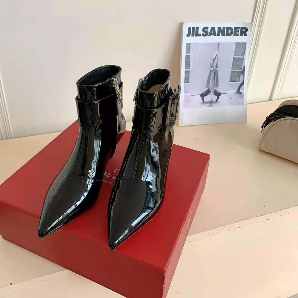 Close-up of covered buckle detail on Roger Vivier ankle boots
