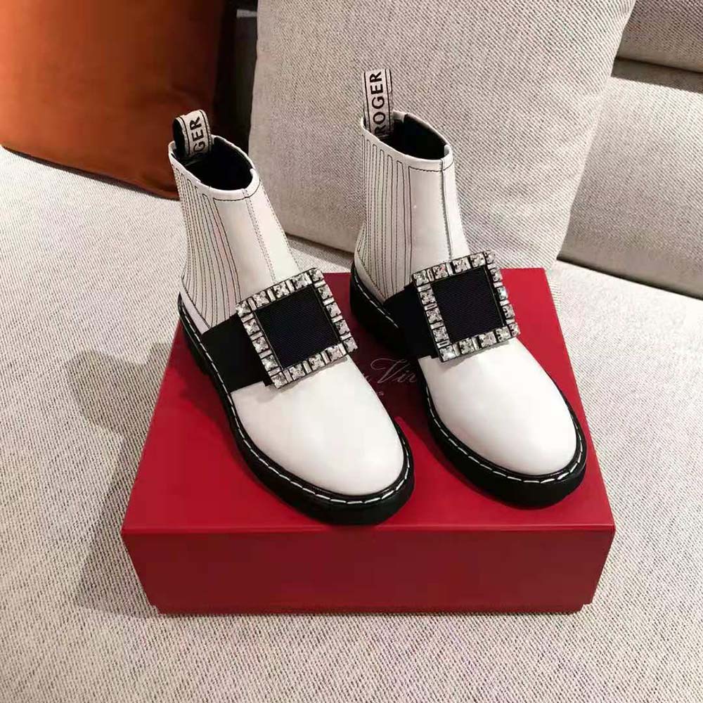 Close-up on strass buckle detail of Roger Vivier Viv’ Rangers white booties