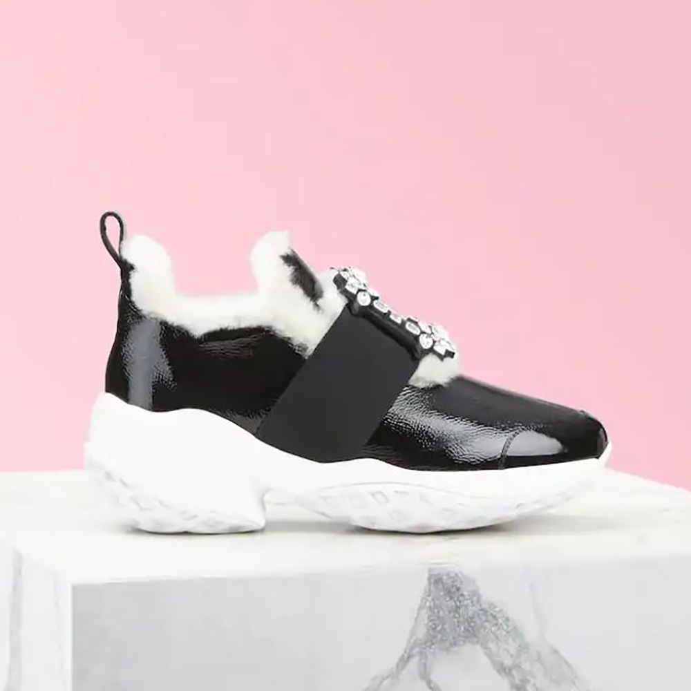 Side view of Roger Vivier Women Viv’ Run Shearling Strass Buckle Sneakers in black patent leather