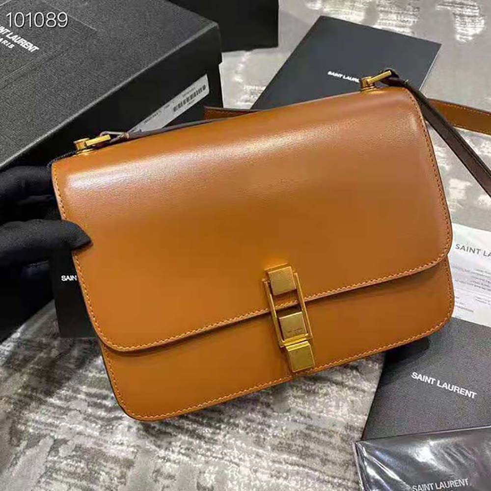 Close-up of YSL gold-tone logo and leather texture on satchel