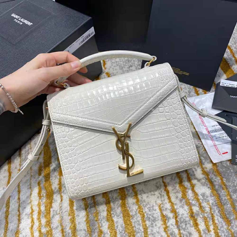 Close-up of gold YSL logo hardware on Cassandra Mini Top Handle Bag