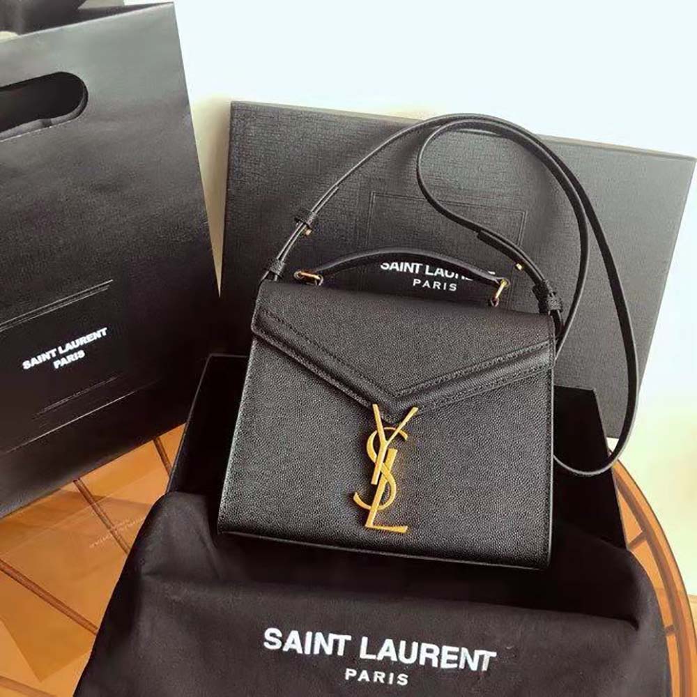 Close-up detail of YSL monogram and grain embossed leather on Cassandra Mini Bag