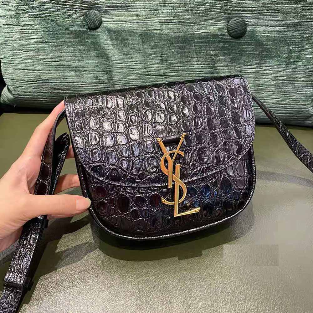 Close-up of gold YSL logo hardware on Kaia Small Satchel