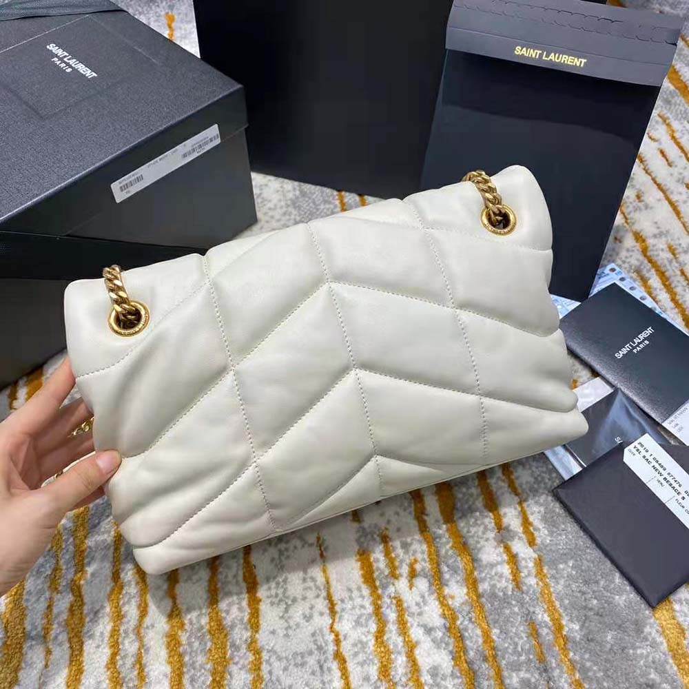 Side view showing silhouette and magnetic closure of Saint Laurent YSL Loulou Puffer bag