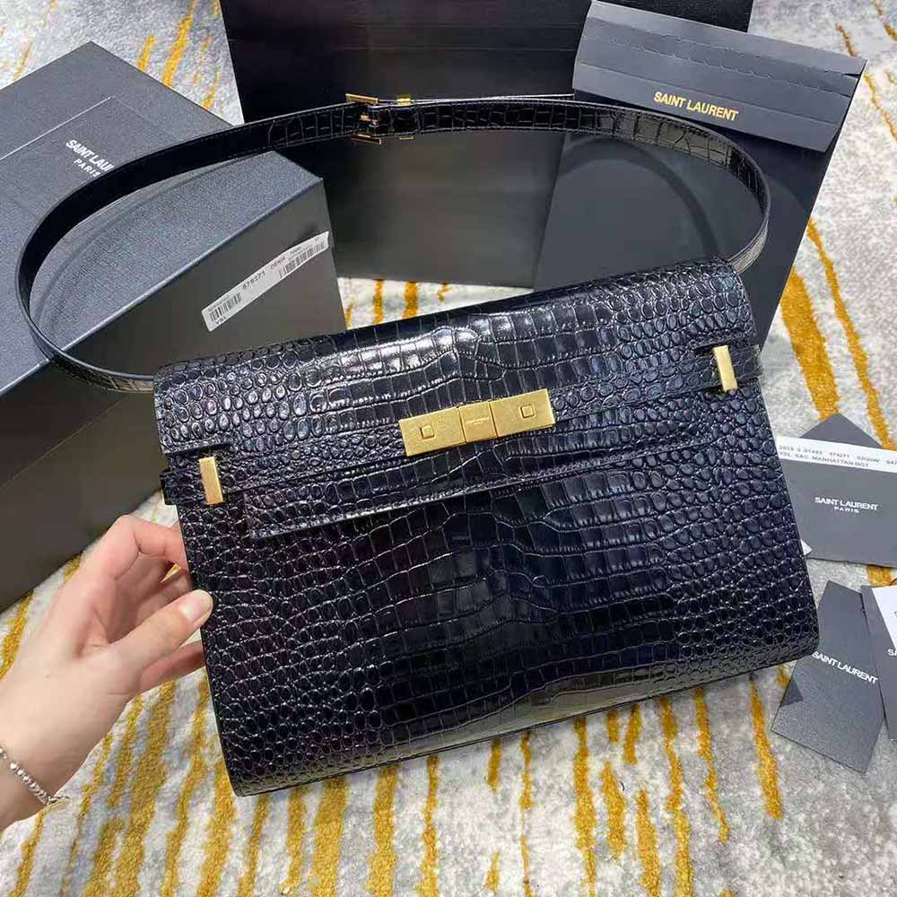 Close-up on antique gold YSL hardware and crocodile embossing details