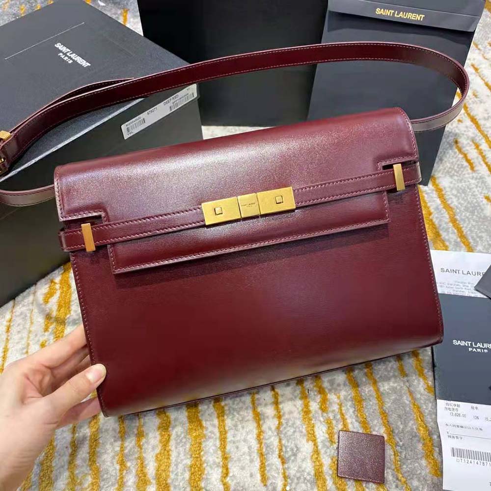 Close-up of gold YSL logo hardware on Manhattan Shoulder Bag maroon leather