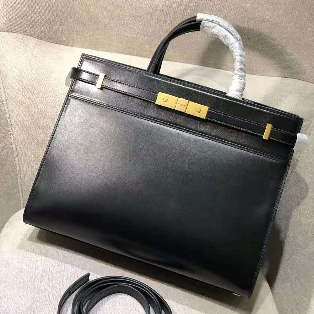 Close-up of YSL gold monogram hardware on the Saint Laurent YSL Women Manhattan Small Shopping