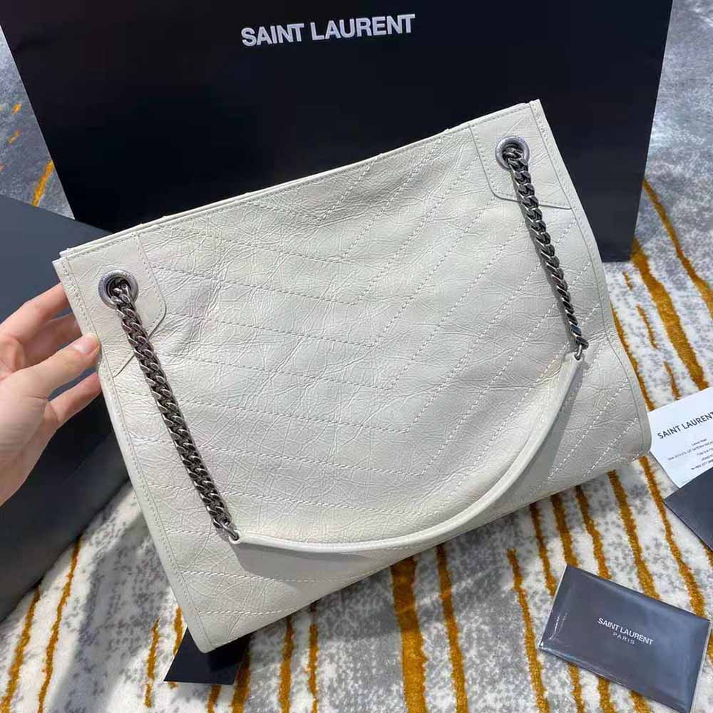 Side angle showing crinkled vintage leather texture on Saint Laurent Niki bag