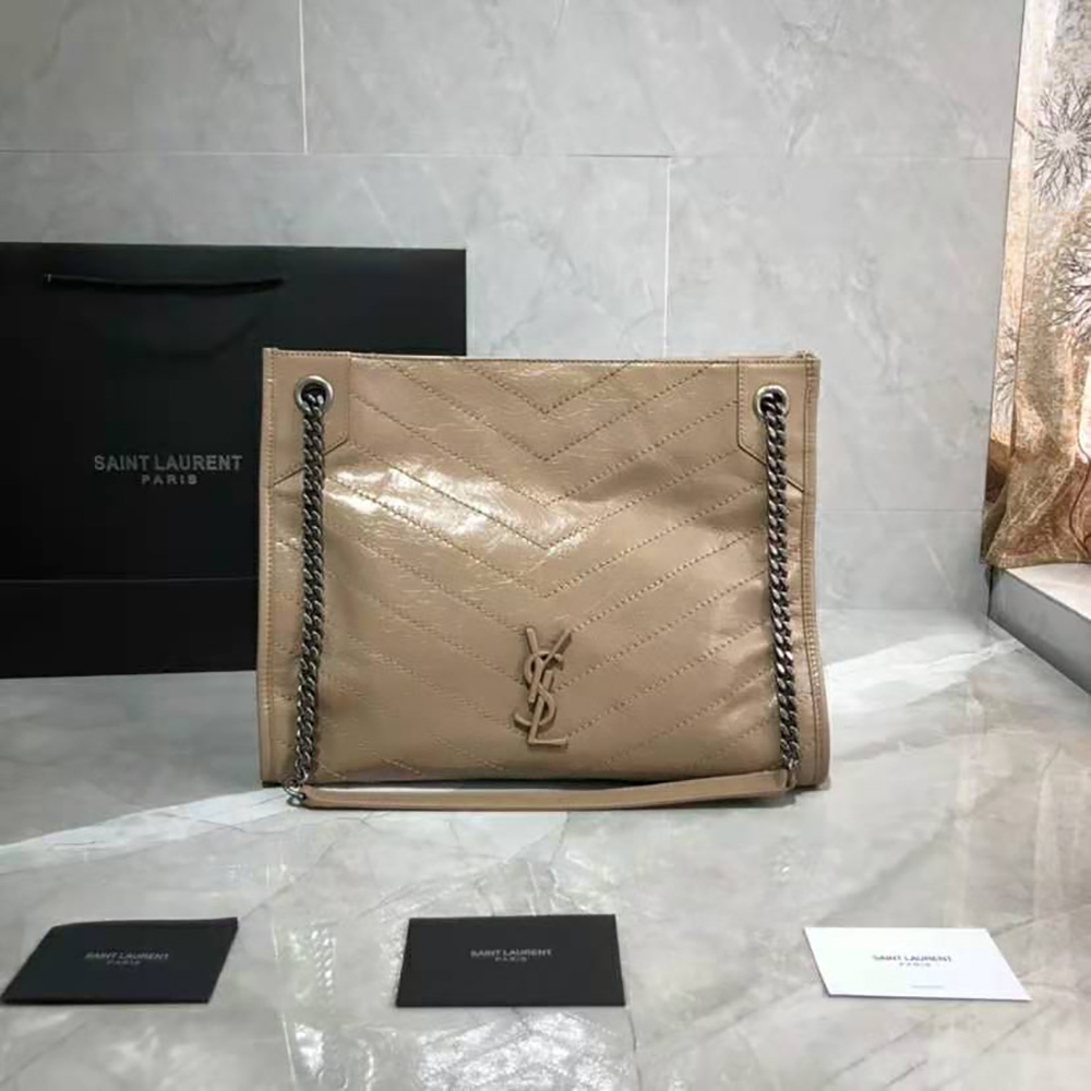 Close-up of gold YSL hardware on pink Niki Medium Shopping Bag