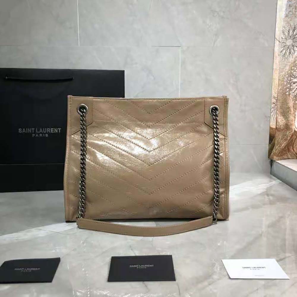 Side angle showing spacious interior and crinkled leather texture of Niki bag