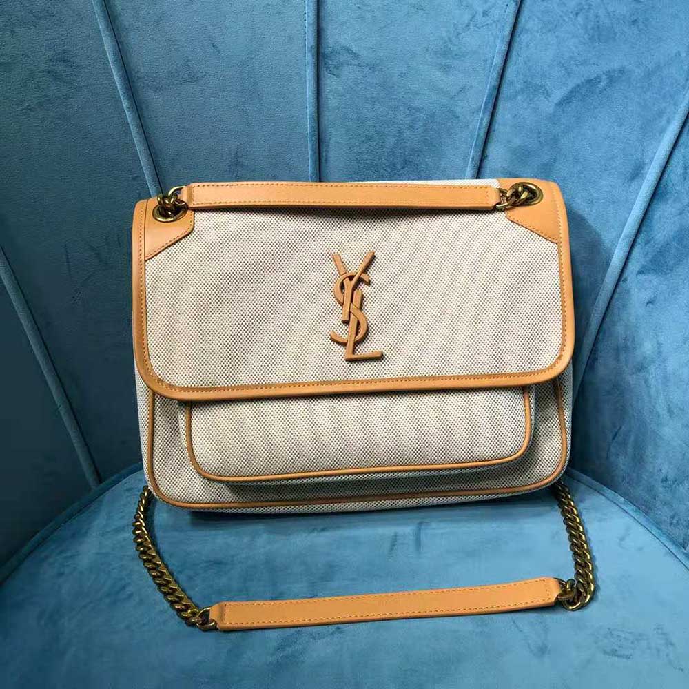 Side angle showing shoulder strap and beige canvas texture