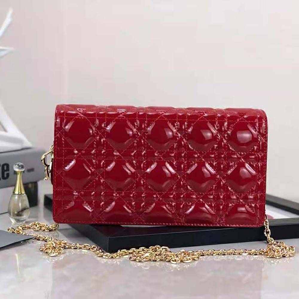 Side profile showcasing zipper and strap details on Dior Lady Dior Pouch Red