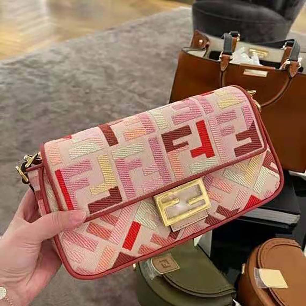 Close-up of gold FF logo clasp on Fendi Women Baguette Bag from the Lunar New Year Collection