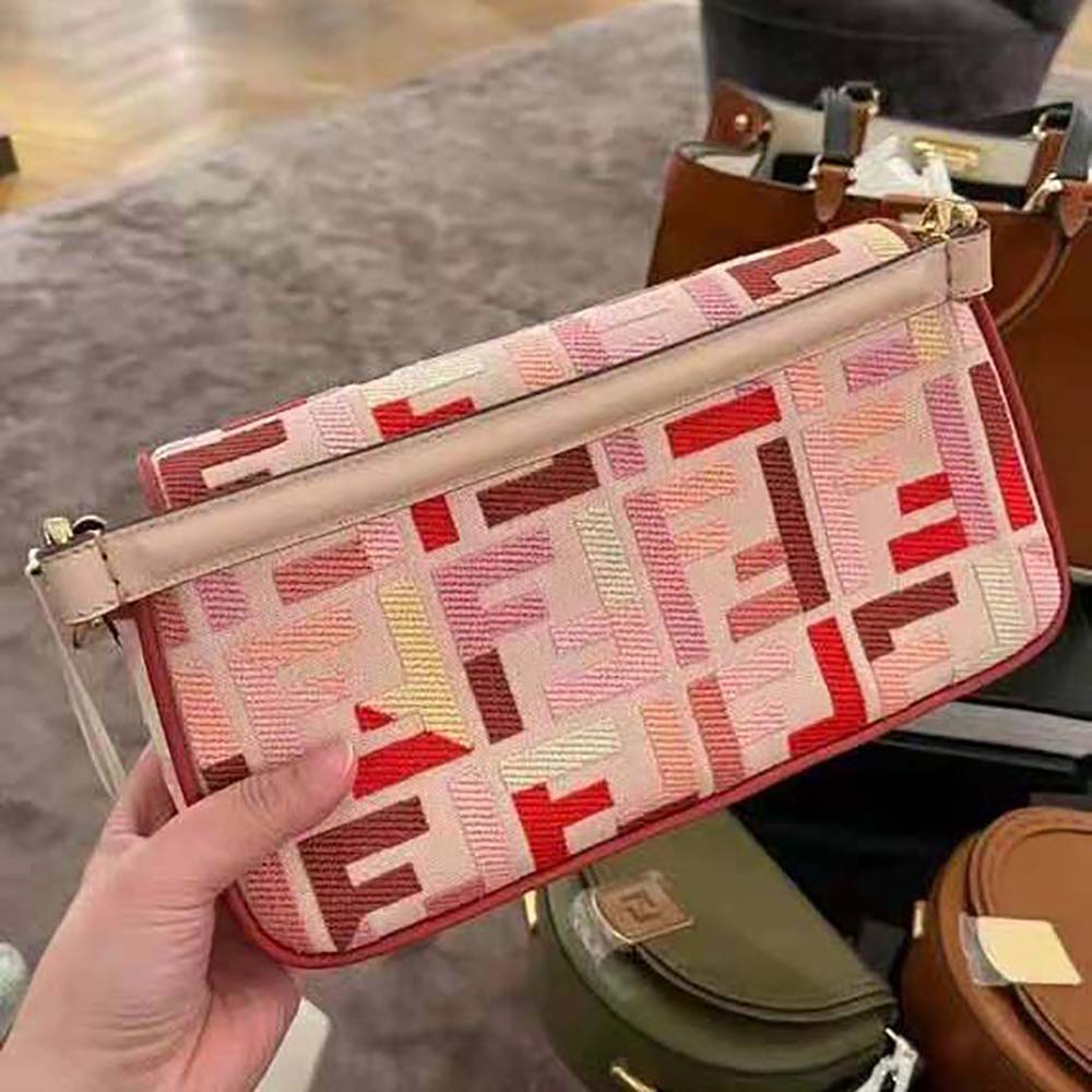 Side angle showing silhouette and pink leather texture of Fendi Women Baguette Bag