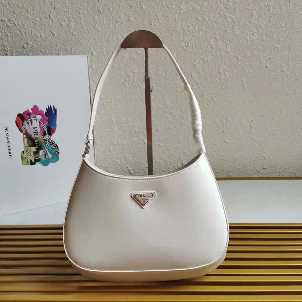 Close-up of gold hardware and magnetic closure on Prada Cleo white bag