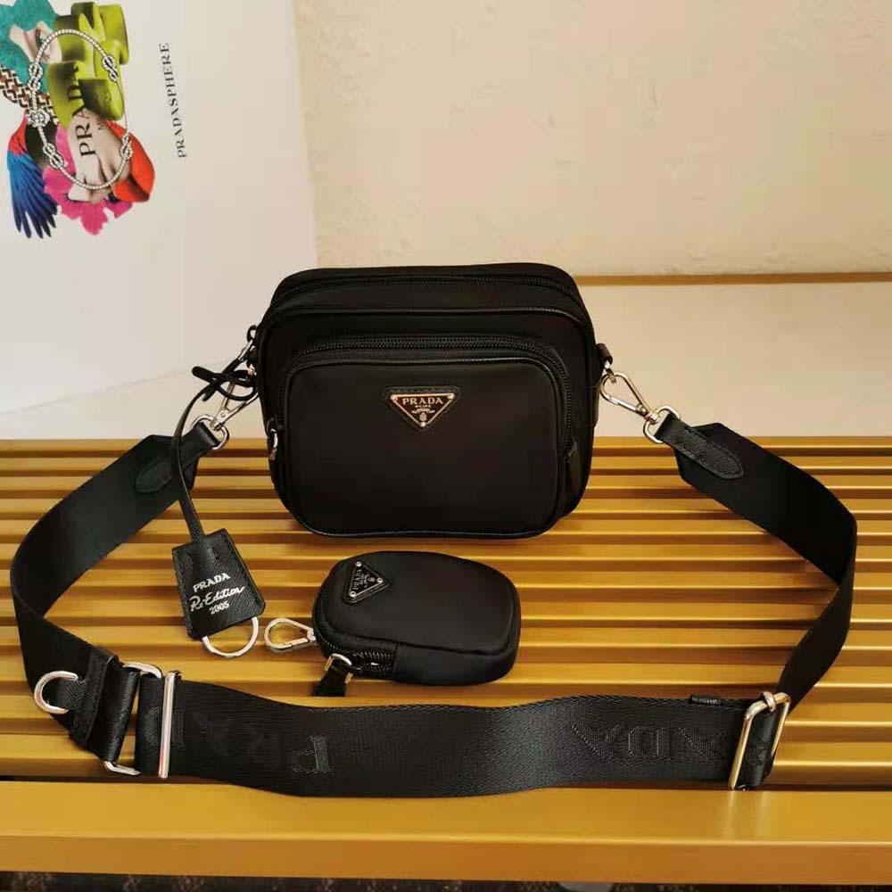 Close-up of Prada triangular logo on Prada Women Prada Re-Edition 2005 Nylon Bag-Black