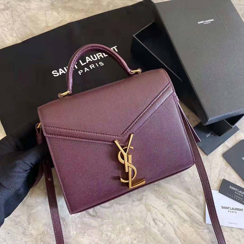 Close-up of gold YSL logo hardware on Cassandra Medium Bag maroon