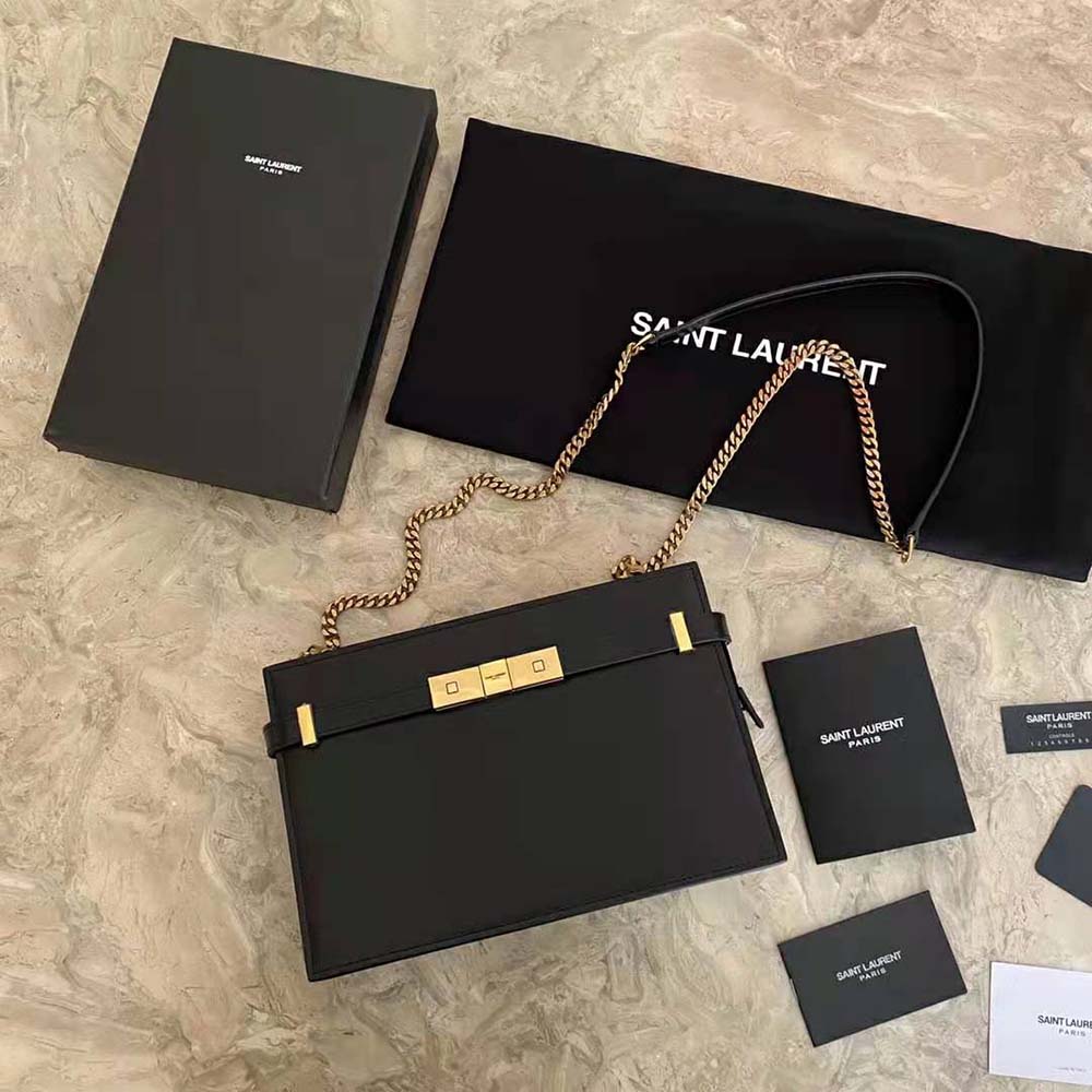 Close-up of gold YSL hardware on black Manhattan Pouch leather