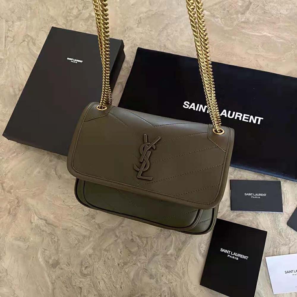 Close-up of gold YSL logo hardware on the Niki Baby lambskin bag
