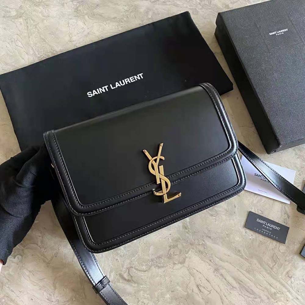 Close-up of gold YSL logo on black box leather Saint Laurent Solferino satchel