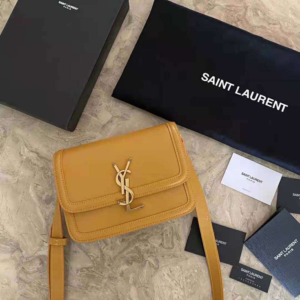 Side profile showing structured silhouette of Saint Laurent YSL yellow satchel