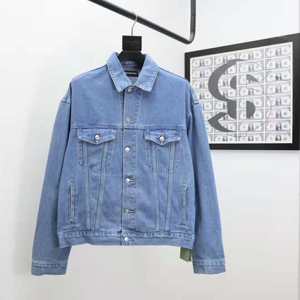 Close-up of metal buttons and stitching on Balenciaga denim jacket