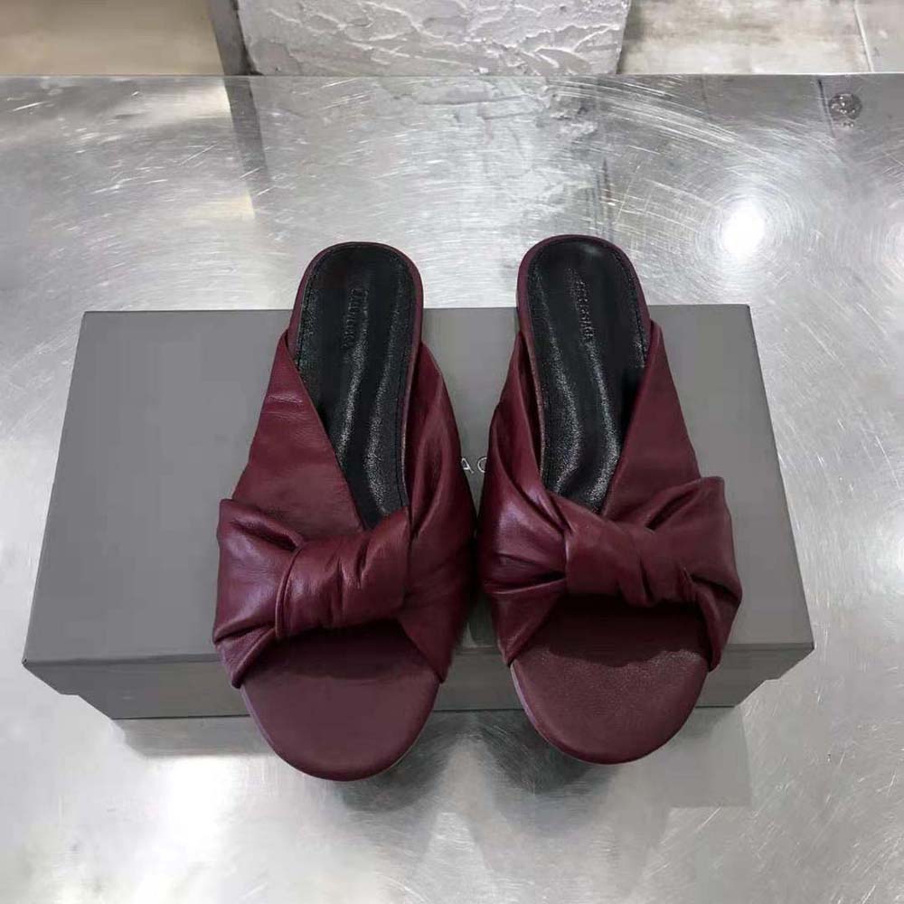 Overhead shot showing flat sole and maroon leather of Balenciaga sandal