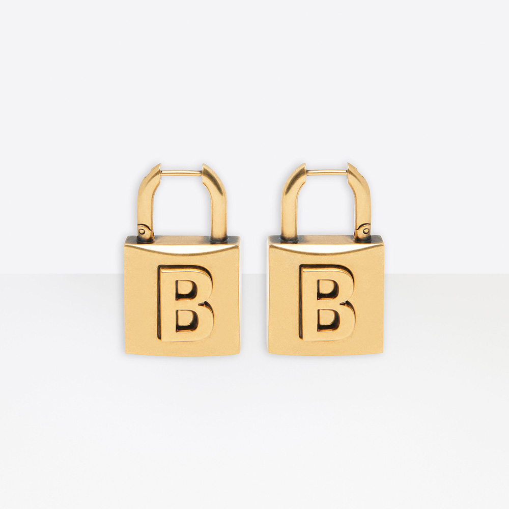 Close-up of Balenciaga Women Lock Small Earrings aged-gold brass detail