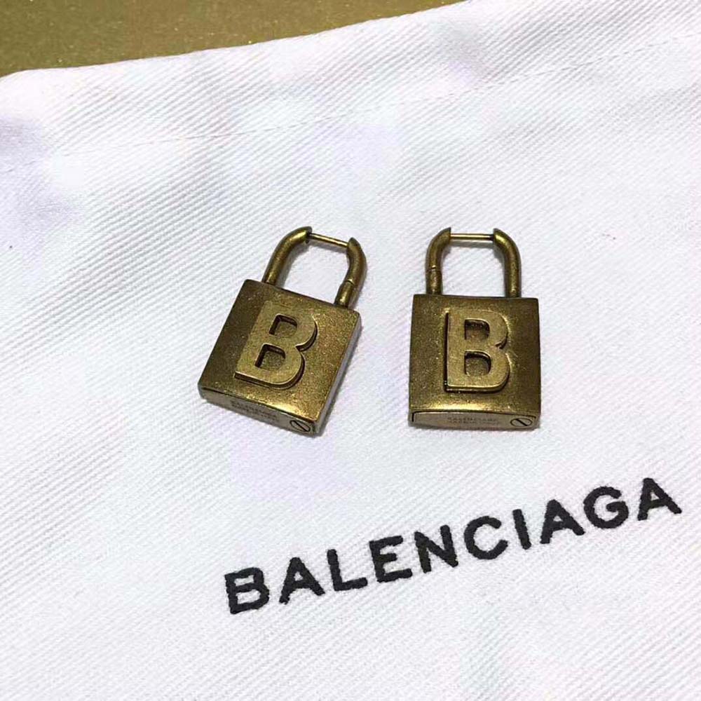 Front view of Balenciaga Women Lock Small Earrings with warm gold shine