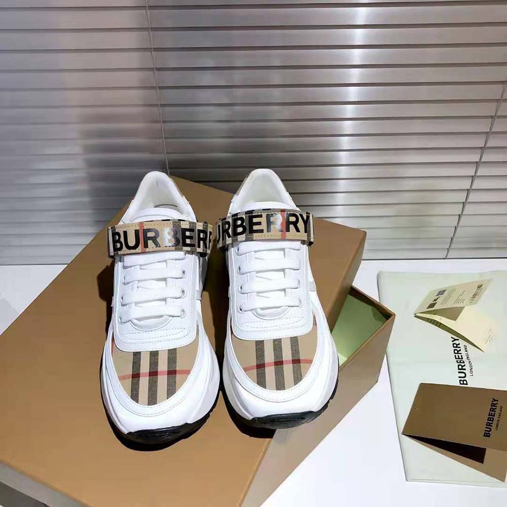 Close-up of Burberry logo detail on white leather and nylon sneaker