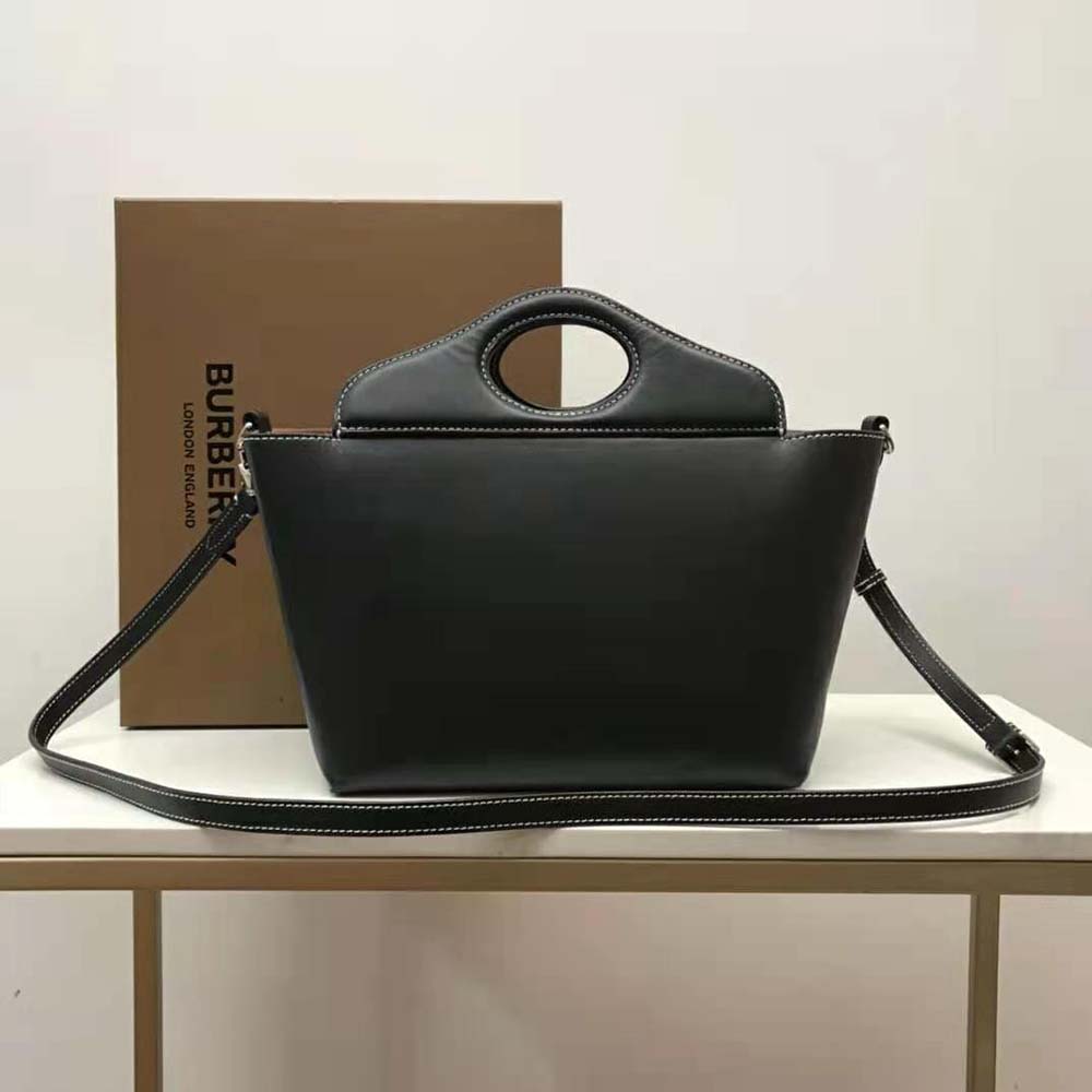 Side angle showing silhouette of Burberry Women Mini Leather Soft Pocket Tote-Black