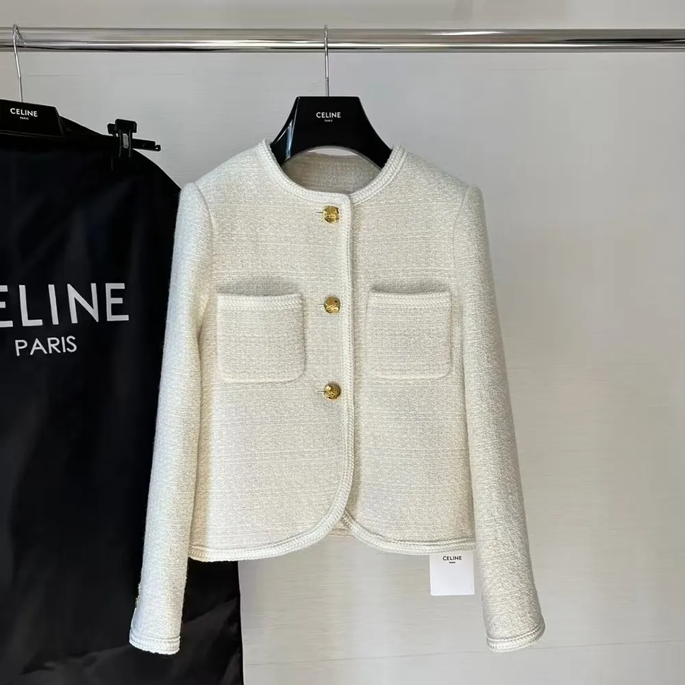 Close-up of gold-tone Celine hardware on white boucle tweed jacket