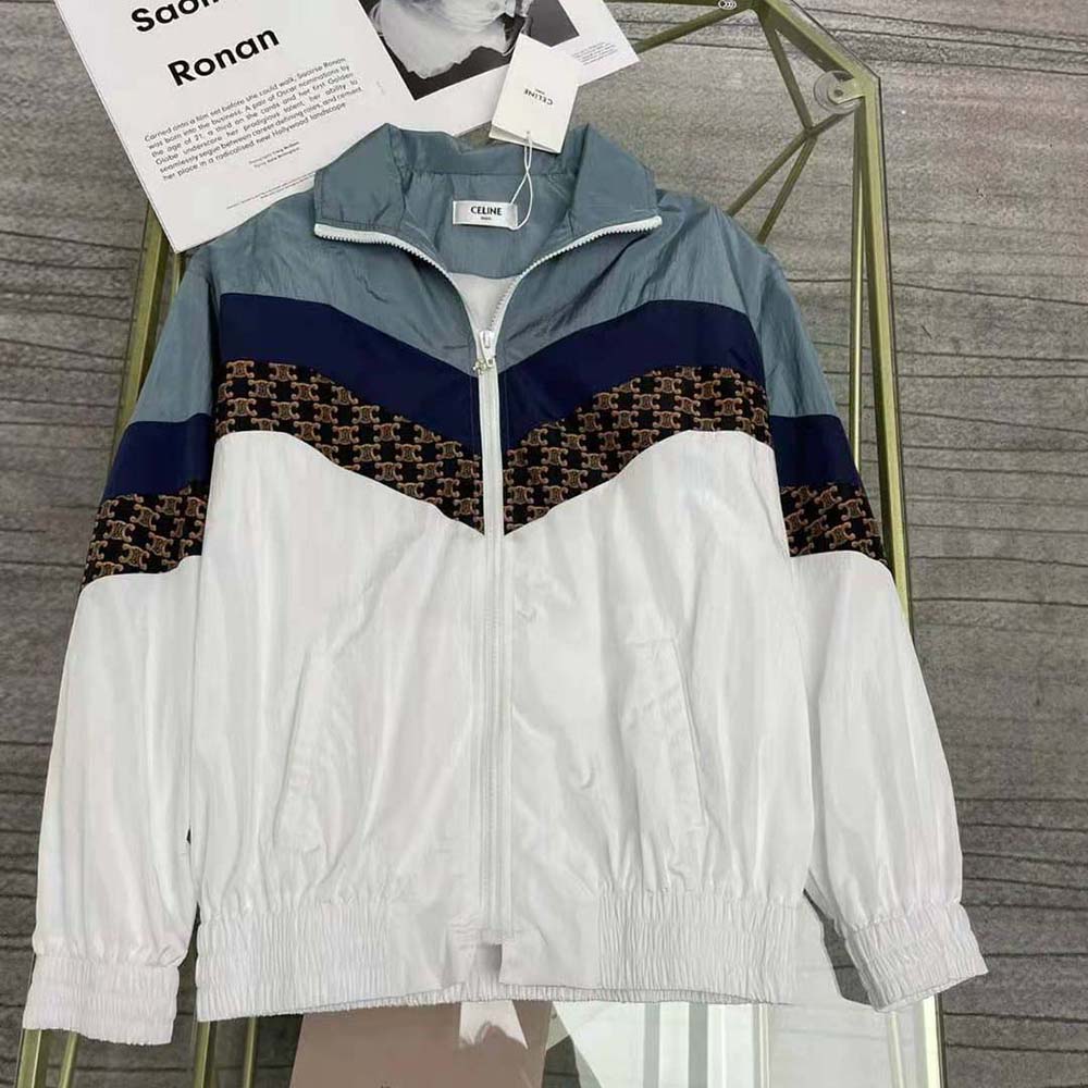 Close-up of Celine monogram detail on white nylon windbreaker