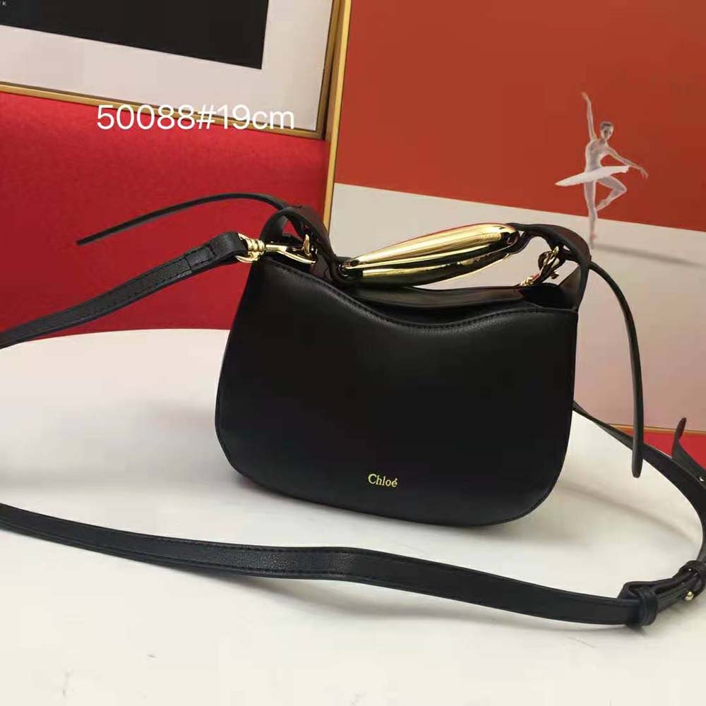 Close-up of gold-tone kiss lock closure on Chloe Women Kiss Small Purse